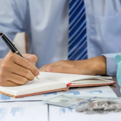 businessman hand writing income and expenses to ac 2023 11 27 05 22 01 utc qvoopay4oz1bc4r27ae0dmhaonivh5pf4ix564rgjs